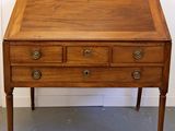 an old wooden desk with three drawers and a drawer on top of it
