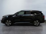 the black suv is parked in a room with a white wall