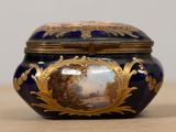 a blue and gold box with a painting on it