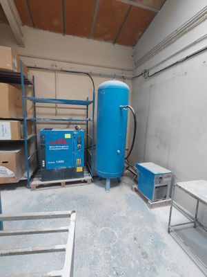 a large blue tank sitting in a room next to a table