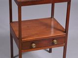 a small wooden table with a drawer on it
