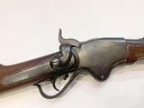 a close up of a gun on display on a white surface