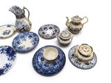 many blue and white plates and cups and saucers
