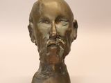 a bronze bust of a man with a beard