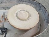 a bucket with a hat on top of it on the ground