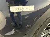 a man standing next to a car with a sticker on it