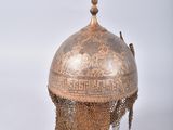 a metal helmet with a chain around it
