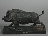 statue of a boar on a marble base on a gray background