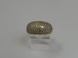 a gold and diamond ring on a clear acrylic stand