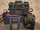 three pieces of luggage sitting on top of a table next to a wall