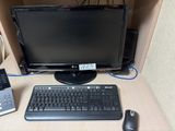 a computer monitor, keyboard, mouse, and phone on a desk