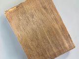 a close up of a piece of wood on a white surface