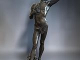 a bronze statue of a woman holding a fan on a wooden base