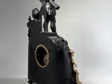 a statue of a man standing on top of a clock