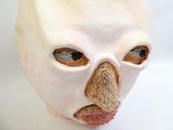 a white mask with a nose and nose on a white surface