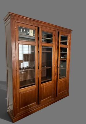 a large wooden cabinet with glass doors on it