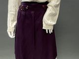 an image of a mannequin wearing a purple skirt and a white blouse