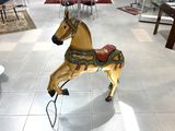 a wooden horse that is on display in a store