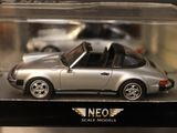 a silver toy car in a clear box on a table