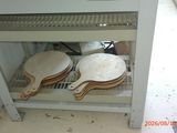 two wooden paddles on a shelf in a kitchen