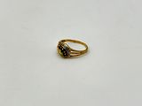 a gold ring with a green stone in the middle