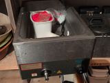 a stove with a pot on top of it in a kitchen