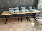 many plates and bowls on a table in a room
