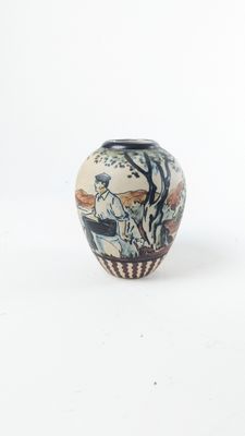 a small vase that is sitting on a white surface