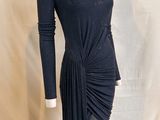 the mannequin is wearing a black dress with a high neck