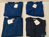 three pairs of men ' s blue and navy shirts with tags on them