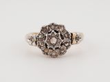 an antique diamond cluster ring in white gold and silver