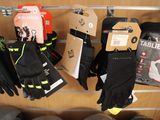 many pairs of gloves hanging on a rack in a store