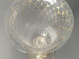 a clear glass bowl with a gold design on it