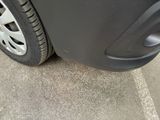 a close up view of a car ' s tire on the street