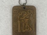 an image of a metal pendant with a picture of a man and a woman
