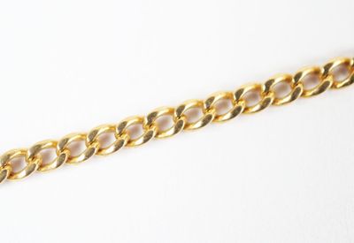 a close up of a gold chain on a white surface