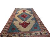a blue and red rug with fringes on a white background