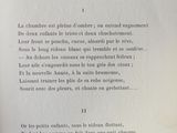 an open book with a poem written in french