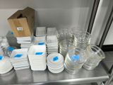 a lot of dishes and cups on a metal shelf