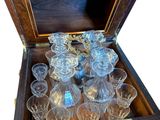 a wooden box with a bunch of glasses inside of it