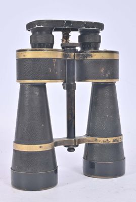 an old pair of binoculars sitting on top of a white surface