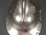 a silver helmet on a table with blood on it