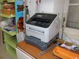 a printer sitting on top of a desk in a room