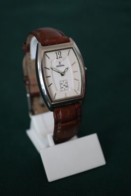 a watch that is sitting on a stand on a table