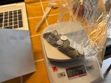 a laptop and a cell phone on a scale on a kitchen counter