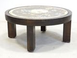 a round table with a marble top and wooden legs