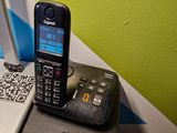 a cell phone sitting on top of a laptop computer