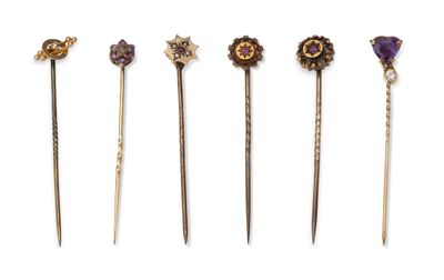 five different types of hair pins are lined up on a white surface