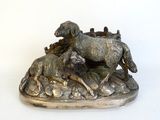 a statue of a horse and a dog running on a hill