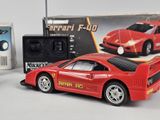 a red toy car next to a remote control car